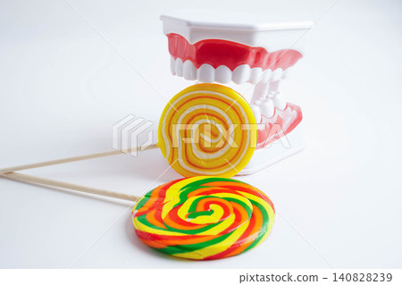 Tooth decay with sweet sugar candy, bad food for dental health care. 140828239