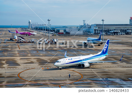 View from the "Sky Deck" at Chubu Centrair International Airport: Domestic passenger planes heading to the runway for takeoff. View from the "Sky Deck" at Chubu Centrair International Airport: Domestic passenger planes heading to the runway for takeoff. 140828433