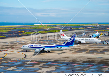 View from the "Sky Deck" at Chubu Centrair International Airport: Domestic passenger planes heading to the runway for takeoff. View from the "Sky Deck" at Chubu Centrair International Airport: Domestic passenger planes heading to the runway for takeoff. 140828499