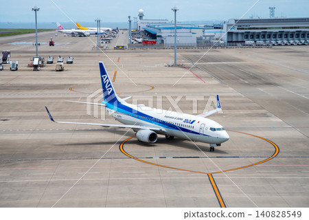 View from the "Sky Deck" at Chubu Centrair International Airport: Domestic passenger planes landing and heading towards the arrival gate. View from the "Sky Deck" at Chubu Centrair International Airport: Domestic passenger planes landing and heading towards the arrival gate. 140828549
