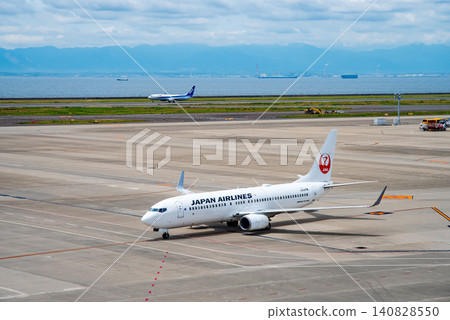 View from the "Sky Deck" at Chubu Centrair International Airport: Domestic passenger planes landing and heading towards the arrival gate. View from the "Sky Deck" at Chubu Centrair International Airport: Domestic passenger planes landing and heading towards the arrival gate. 140828550