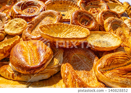 Close up of traditional Central Asian round flatbread with spiral pattern at Tajik market stall 140828852