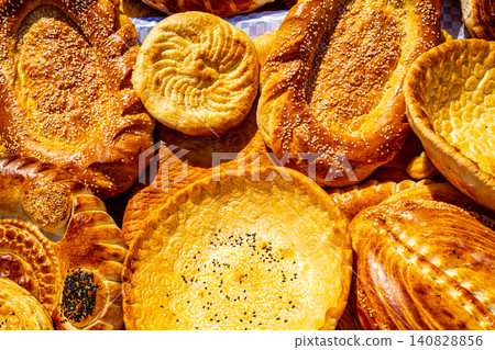 Close up of traditional Central Asian round flatbread with spiral pattern 140828856
