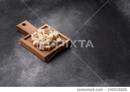 White feta, tofu, or mozzarella cheese cubes with herbs. White mozzarella cheese White feta, tofu, or mozzarella cheese cubes with herbs. White mozzarella cheese 140828880