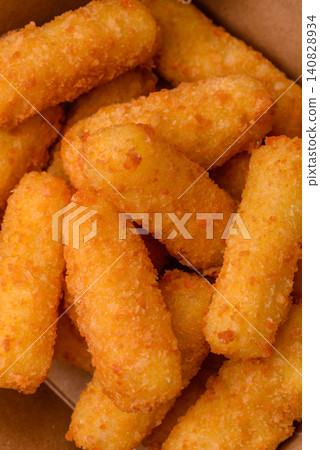 Mozzarella cheese sticks, breaded and fried with salt and tomato sauce, for takeaway. Cheese sticks Mozzarella cheese sticks, breaded and fried with salt and tomato sauce, for takeaway. Cheese sticks 140828934
