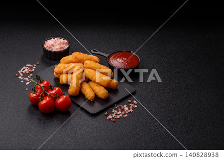 Mozzarella cheese sticks, breaded and fried with salt and tomato sauce, for takeaway. Cheese sticks Mozzarella cheese sticks, breaded and fried with salt and tomato sauce, for takeaway. Cheese sticks 140828938