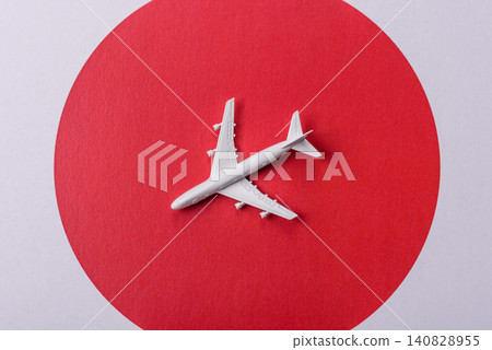 An airplane on the japanese flag as a conceptual backdrop. An airplane on the japanese flag An airplane on the japanese flag as a conceptual backdrop. An airplane on the japanese flag 140828955