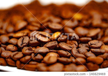 Coffee beans on a white plate. dark background Coffee beans on a white plate. dark background 140829469