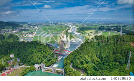 The red Aimoto Bridge spanning the Kurobe River and the surrounding area of the vast Kurobe River alluvial fan. The red Aimoto Bridge spanning the Kurobe River and the surrounding area of the vast Kurobe River alluvial fan. 140829620
