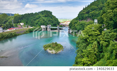The red Aimoto Bridge spanning the Kurobe River and the surrounding area of the vast Kurobe River alluvial fan. The red Aimoto Bridge spanning the Kurobe River and the surrounding area of the vast Kurobe River alluvial fan. 140829633