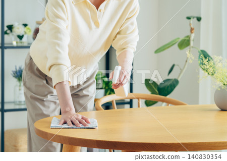 The hands of a young woman wiping a table The hands of a young woman wiping a table 140830354