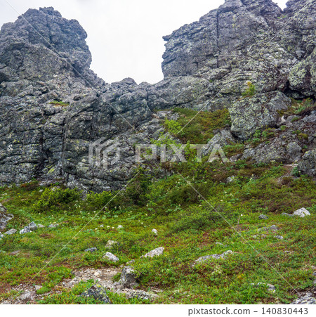 Mountain landscape with green grass, rocks and vegetation in summer. Mountain landscape with green grass, rocks and vegetation in summer. 140830443
