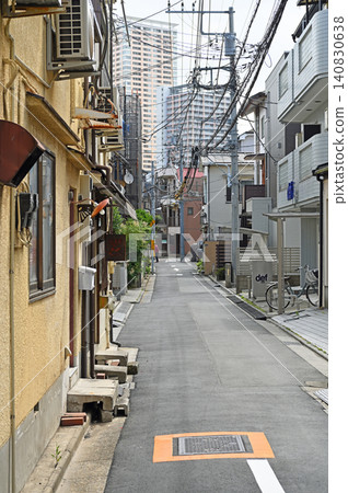 A modern tower apartment building stands tall in the back alleys where old and new intersect, amidst the old streets of Yanaka, Nezu, and Sendagi. A modern tower apartment building stands tall in the back alleys where old and new intersect, amidst the old streets of Yanaka, Nezu, and Sendagi. 140830638
