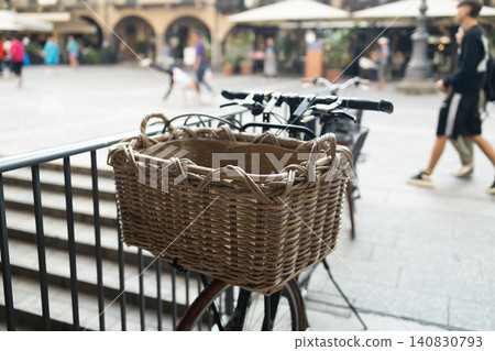 Vintage bicycle with a wicker basket parked on a street in Como Italy Vintage bicycle with a wicker basket parked on a street in Como Italy 140830793