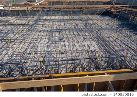 Overhead view of the reinforcement bar assembly of the foundation slab. Overhead view of the reinforcement bar assembly of the foundation slab. 140830816