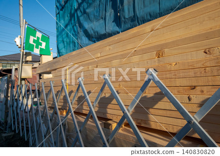 Stacking lumber and safety fences at a construction site Stacking lumber and safety fences at a construction site 140830820