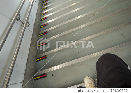Station staircase handrails and yellow and red anti-slip tape Station staircase handrails and yellow and red anti-slip tape 140830822