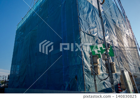 工地外牆覆蓋著藍色防護布。 工地外牆覆蓋著藍色防護布。 140830825