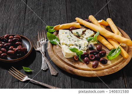 Premium blue cheese board with grissini and olives Premium blue cheese board with grissini and olives 140831580
