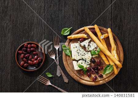 Premium blue cheese board with grissini and olives Premium blue cheese board with grissini and olives 140831581