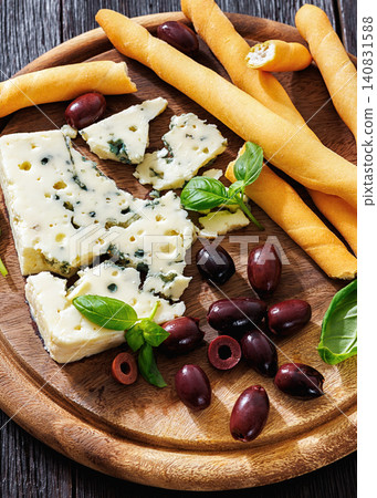 Premium blue cheese board with grissini and olives Premium blue cheese board with grissini and olives 140831588