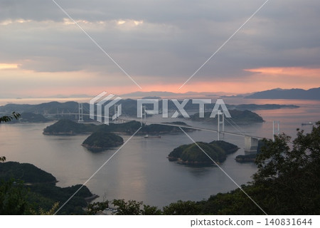 The large bridges of the Seto Inland Sea and the islands illuminated by the setting sun. The large bridges of the Seto Inland Sea and the islands illuminated by the setting sun. 140831644