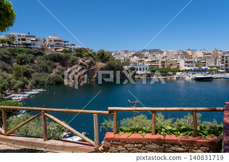 Panoramic view of Lake Voulismeni from a high viewpoint with a wooden fence in Agios Nikolaos, Crete, Greece Panoramic view of Lake Voulismeni from a high viewpoint with a wooden fence in Agios Nikolaos, Crete, Greece 140831719