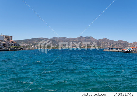Panoramic view of the sea bay and mountains under clear blue sky in Agios Nikolaos, Crete, Greece Panoramic view of the sea bay and mountains under clear blue sky in Agios Nikolaos, Crete, Greece 140831742