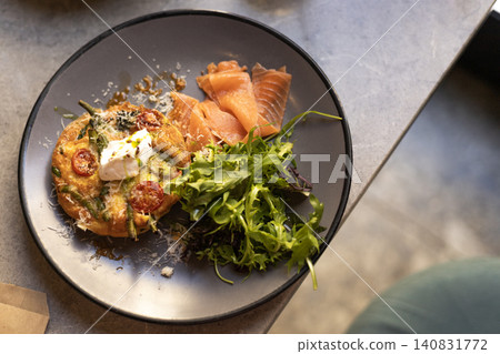Salmon breakfast platter with frittata and green salad on dark plate Salmon breakfast platter with frittata and green salad on dark plate 140831772