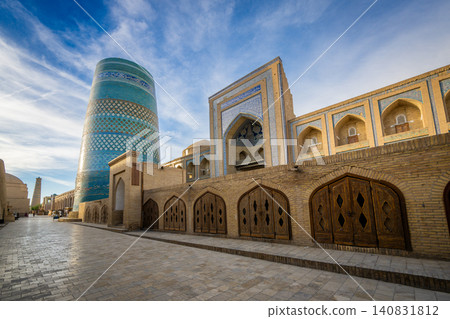 Khiva-Ichan Kala, a UNESCO World Heritage Site in Uzbekistan: Kalta Minor and its historic streets shining under the blue sky. Khiva-Ichan Kala, a UNESCO World Heritage Site in Uzbekistan: Kalta Minor and its historic streets shining under the blue sky. 140831812