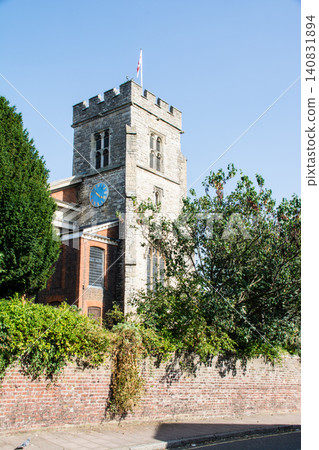 A historic stone church under a clear blue sky in the Teddington neighborhood on the outskirts of London. A historic stone church under a clear blue sky in the Teddington neighborhood on the outskirts of London. 140831894
