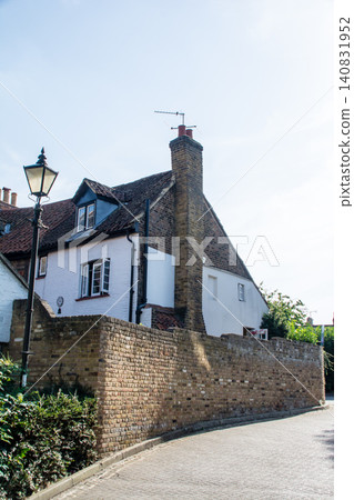 Historic brick and stone buildings bathed in bright sunlight: the streets of Teddington, a suburb of London. Historic brick and stone buildings bathed in bright sunlight: the streets of Teddington, a suburb of London. 140831952