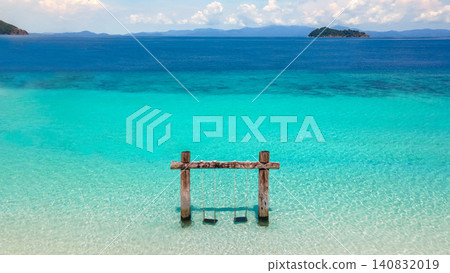 Empty twin wooden swing on Madam beach of Nyaung Oo Phee Island in Myanmar or Burma Empty twin wooden swing on Madam beach of Nyaung Oo Phee Island in Myanmar or Burma 140832019