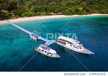 Aerial view of tour boats in front of the resort at Nyaung Oo Phee island in Myanmar. Aerial view of tour boats in front of the resort at Nyaung Oo Phee island in Myanmar. 140832026