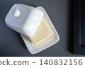 Domestic fresh block of butter in white ceramic box. Baking or cooking ingredient. 140832156