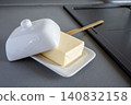 Domestic fresh block of butter in white ceramic box. Baking or cooking ingredient. 140832158