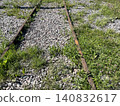 Abandoned railway tracks overgrown with grass and wildflowers, suitable for background use 140832617