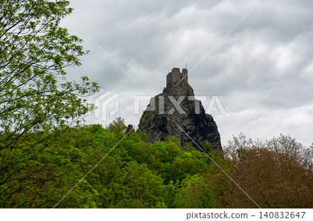 Iconic towers of Trosky Castle Ruins rising on ancient volcanic rock formations beneath dramatic stormy skies in the beautiful Bohemian Paradise, Czech Republic. Iconic towers of Trosky Castle Ruins rising on ancient volcanic rock formations beneath dramatic stormy skies in the beautiful Bohemian Paradise, Czech Republic. 140832647