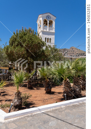 Vertical shot of the white clock tower and belfry of the Orthodox Church of Saints Constantine and Helena in Elounda, Crete, Greece 140832851