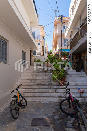 Vertical shot of bicycles parked at the bottom of traditional stone steps in a narrow street of Elounda, Crete, Greece Vertical shot of bicycles parked at the bottom of traditional stone steps in a narrow street of Elounda, Crete, Greece 140832860