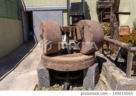 Vintage stone olive mill with grinding wheels for oil extraction Vintage stone olive mill with grinding wheels for oil extraction 140833043