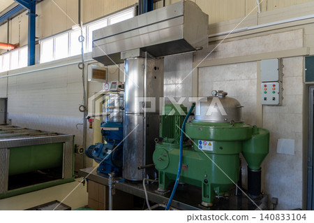 Industrial centrifuge separator machine in olive oil extraction factory Industrial centrifuge separator machine in olive oil extraction factory 140833104