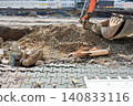 Bulldozer bucket for repair reconstruction work on the asphalt road in big city. Earth moving machine. Street road renovation. 140833116