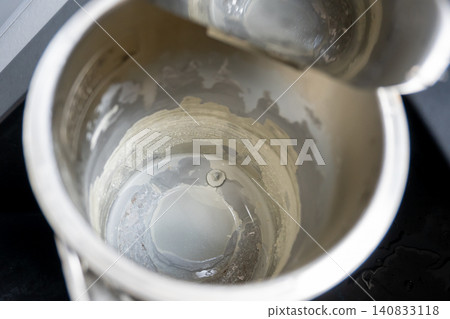 Black electric teapot with limescale surface. Hard water in metal kettle in the kitchen.Black electric teapot with limescale surface. Hard water in metal kettle in the kitchen. Black electric teapot with limescale surface. Hard water in metal kettle in the kitchen.Black electric teapot with limescale surface. Hard water in metal kettle in the kitchen. 140833118