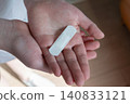 Young woman with medical adhesive plaster on the hand after vaccination. Fabric white bandage like first help for wound on the damage skin.  140833121