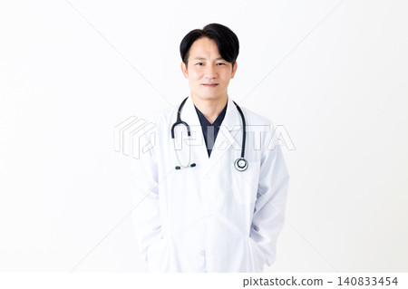 Middle-aged male doctor wearing a white coat Middle-aged male doctor wearing a white coat 140833454