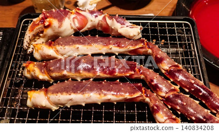 close up of a Japanese premium Alaskan-style king crab legs sizzling on a hot grill. crab legs feature purple-red shells with succulent white meat with copy space close up of a Japanese premium Alaskan-style king crab legs sizzling on a hot grill. crab legs feature purple-red shells with succulent white meat with copy space 140834208