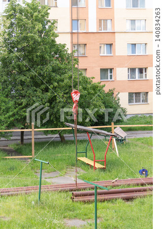 Rusty metal pipes stored on the green grass of a residential playground for utility repair works Rusty metal pipes stored on the green grass of a residential playground for utility repair works 140834263