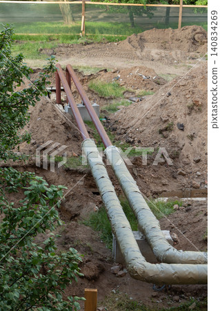 Pipeline replacement process with wrapped industrial pipes running through dug earth and trenches Pipeline replacement process with wrapped industrial pipes running through dug earth and trenches 140834269