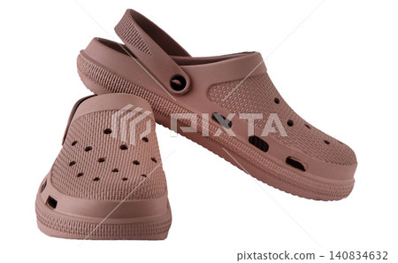 Pair of dusty rose rubber clogs isolated on white background Pair of dusty rose rubber clogs isolated on white background 140834632
